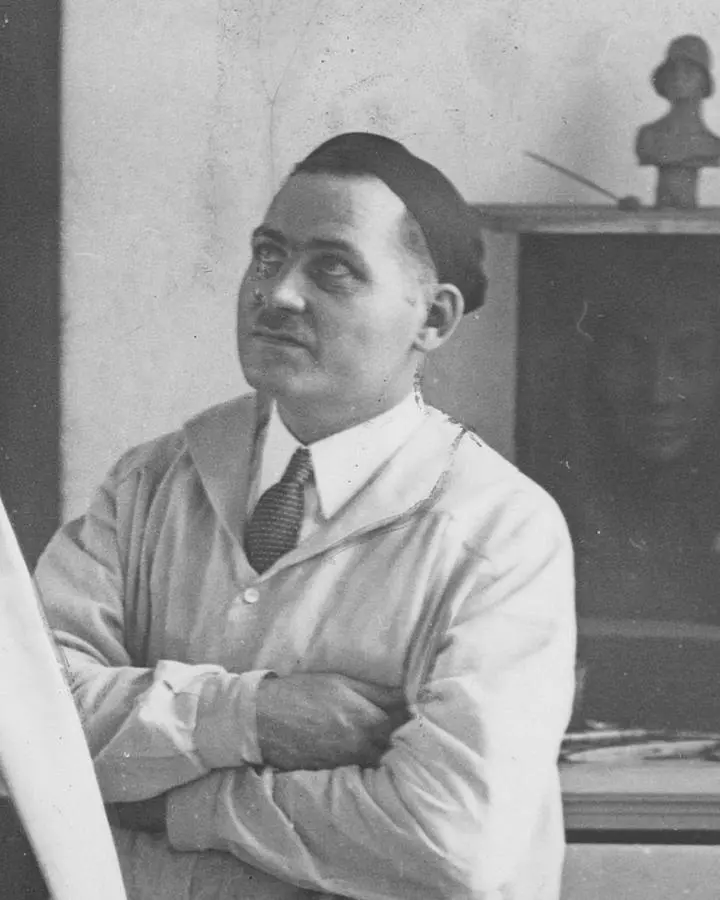 Sculptor Oskar J.W. Hansen in his studio beside a winged figure for Minneapolis's Rand Tower, 1929
