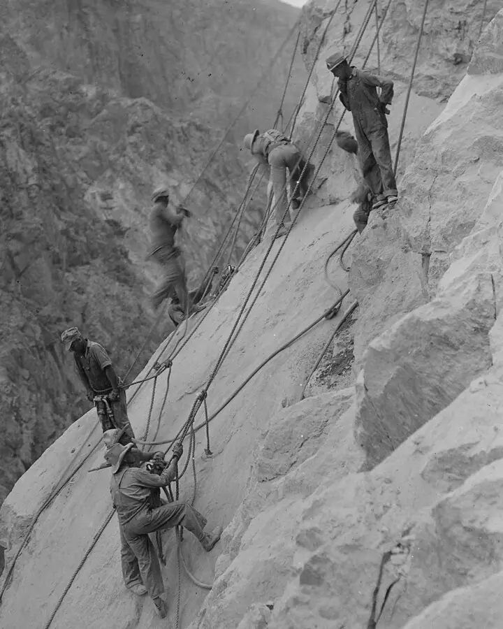 High scalers on ropes at the Arizona intake tower site, some 550 feet above the Colorado River, 28 July 1932: the job Joe Kine did at the dam.
