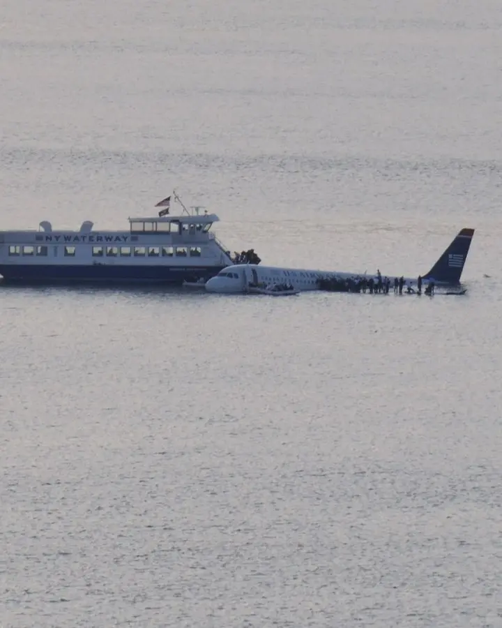 The NY Waterway ferry Thomas Jefferson, Capt. Vincent Lombardi, pulls alongside Flight 1549 as passengers wait on the wing, 15 January 2009