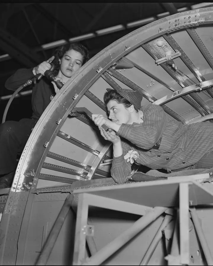 Women build a B-24 wing section at Willow Run, where Rose Will Monroe riveted. No free photo of Monroe herself is available.