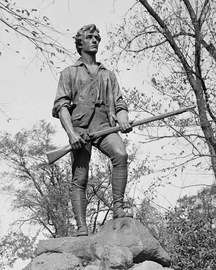 The Lexington Minuteman by Henry Hudson Kitson (1900), long called the statue of Capt. John Parker, on Lexington Green in 1929. No free portrait of John Parker is available.