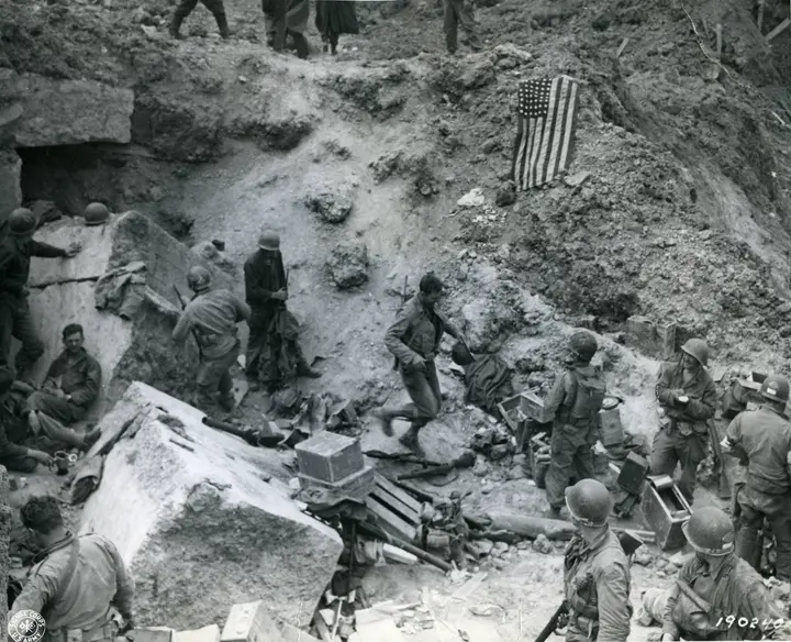 Rangers' command post atop Pointe du Hoc with the U.S. flag spread to stop friendly fire, June 1944