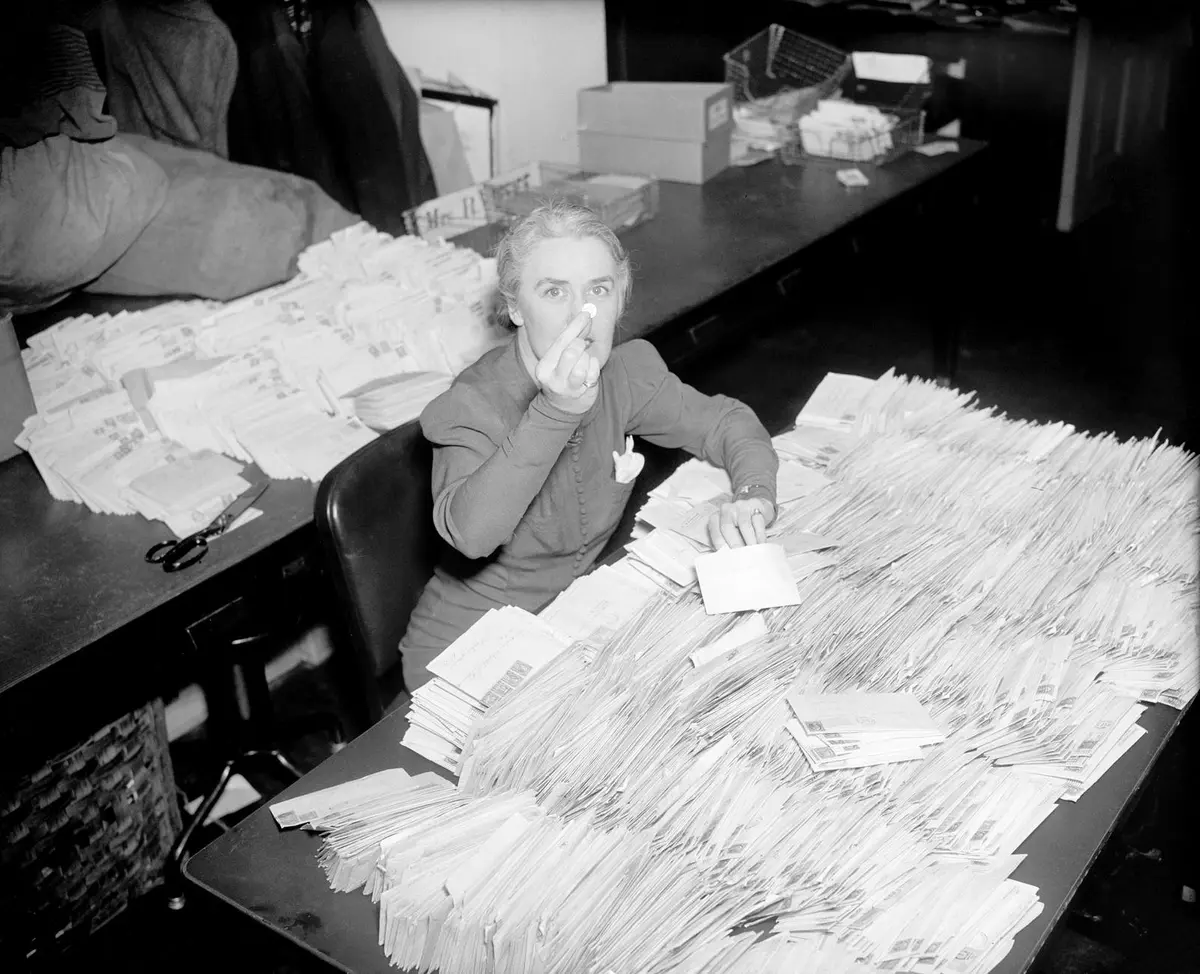Missy LeHand, President Roosevelt’s secretary, digs through the first March of Dimes mail at the White House, 28 January 1938.