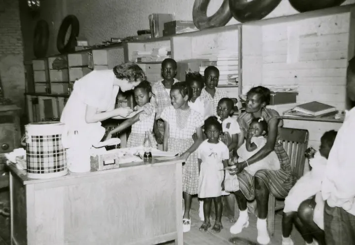 Families wait their turn at a polio vaccine clinic in Mississippi, 1956.