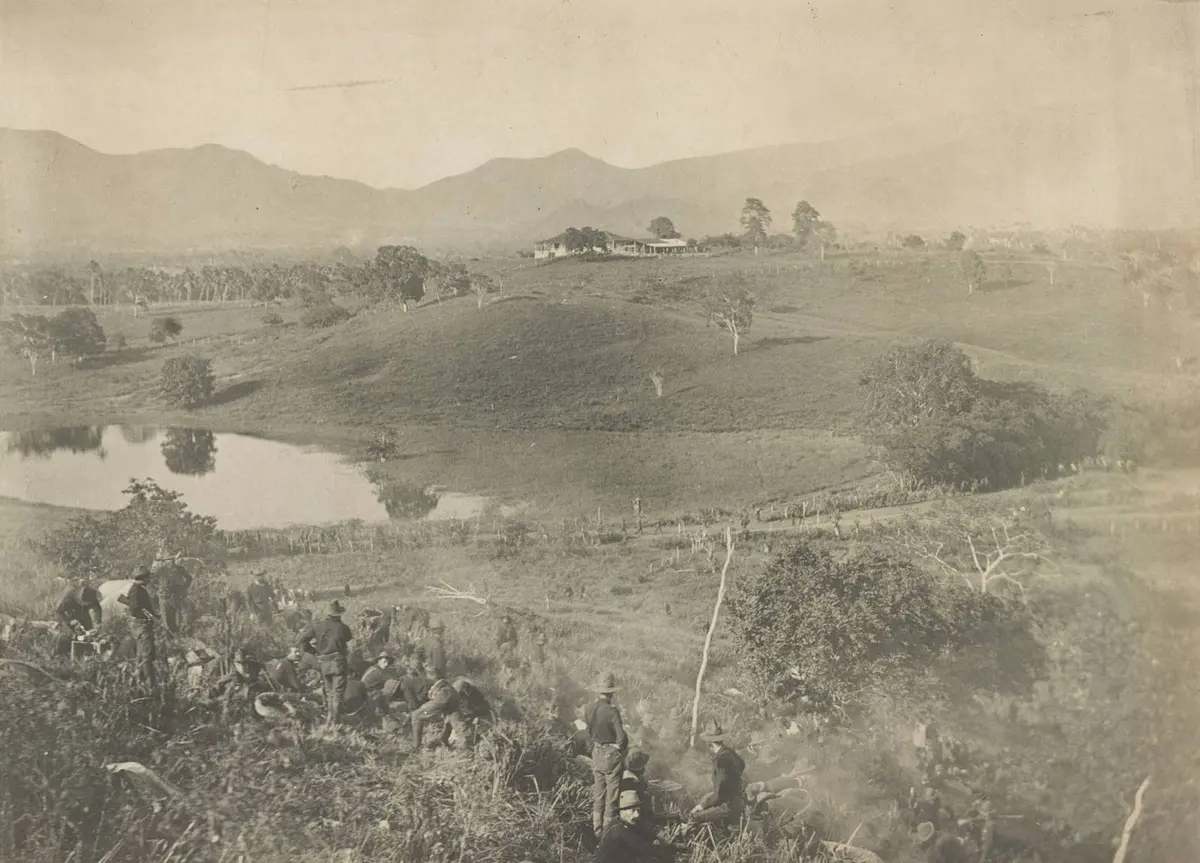 The hill from which the dismounted cavalry division charged the San Juan Heights, with the lagoon below and the mountains behind Santiago, 1898