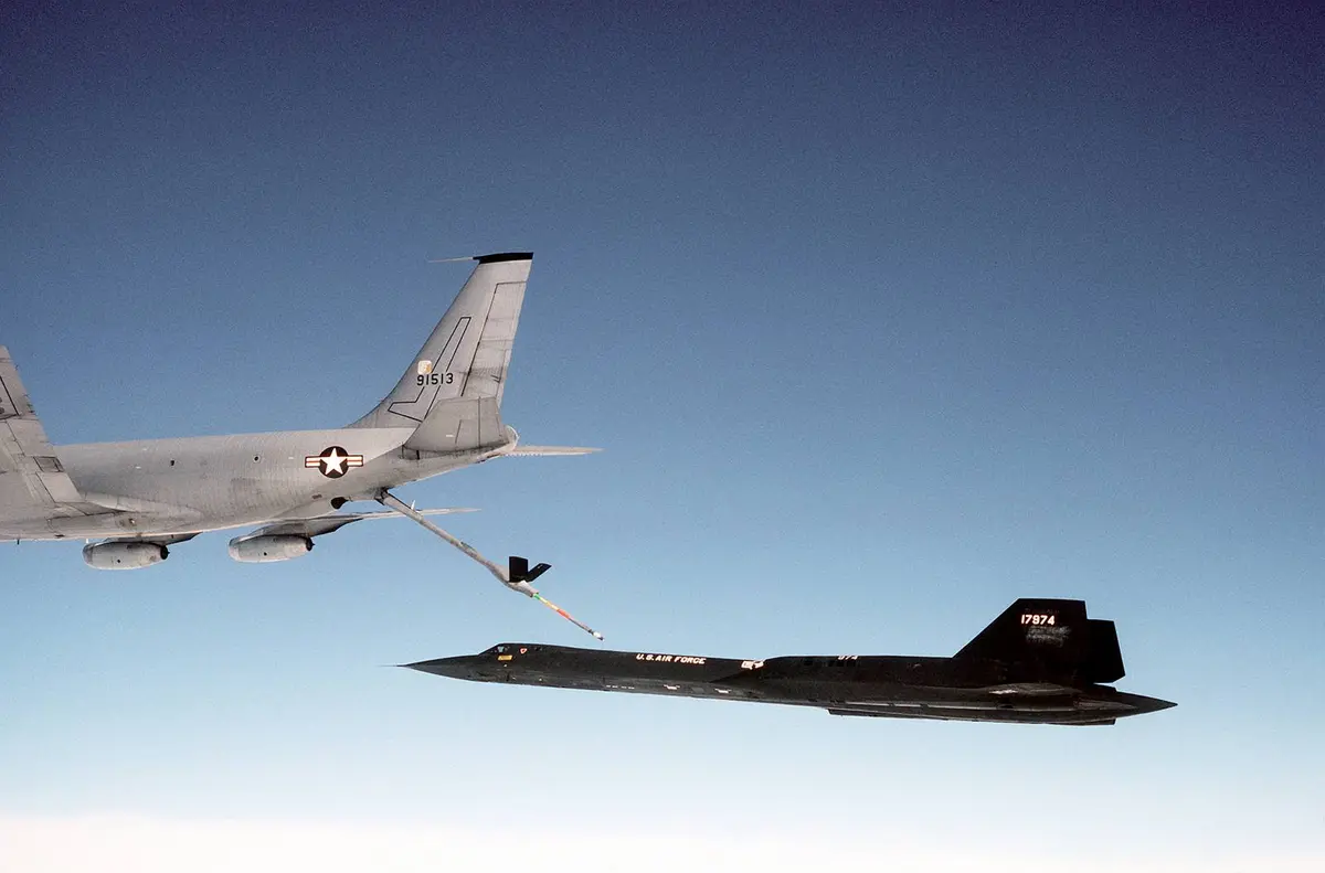 An SR-71 of the 9th Strategic Reconnaissance Wing slides in behind a KC-135Q tanker to take on fuel.