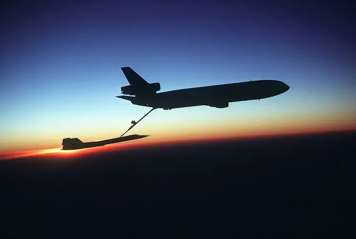 A Blackbird of the 9th Strategic Reconnaissance Wing refuels from a KC-10 Extender against the sunset.