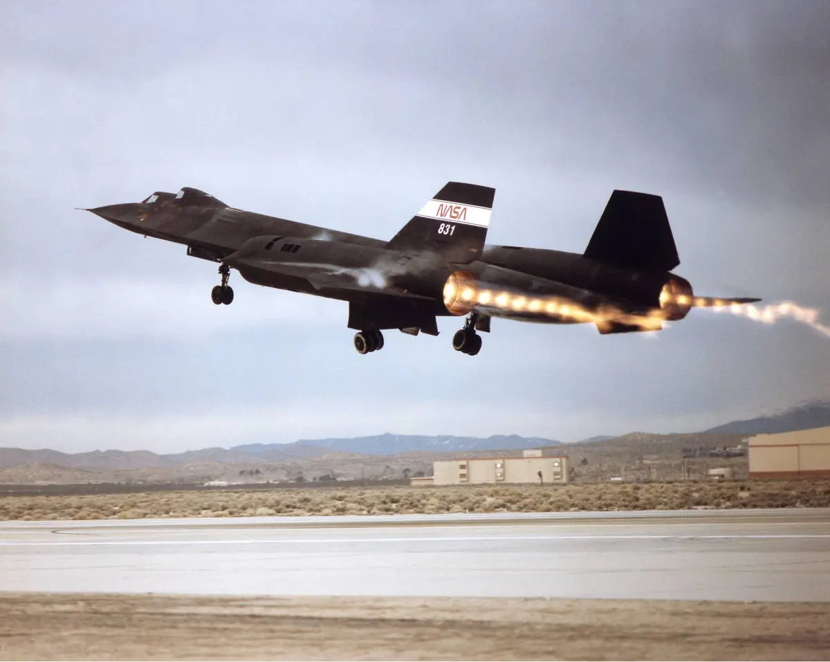 Shock diamonds stream from both J58 engines as NASA's SR-71B leaves the runway at Edwards in 1992.