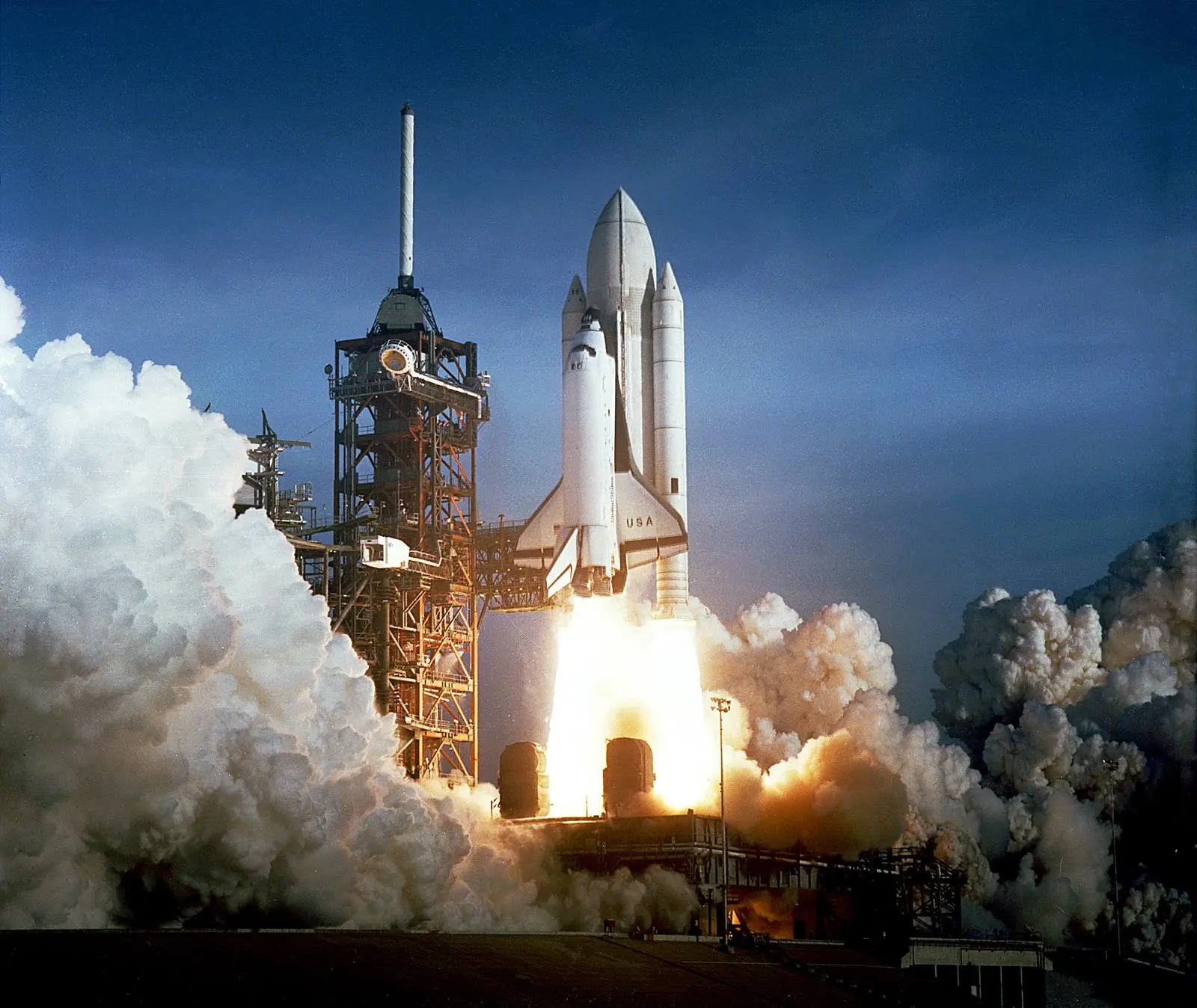 Columbia rises from Pad 39A just after 7 a.m. on 12 April 1981, its external tank still painted white, the first time a crew rode a spacecraft on its maiden launch (KSC-81PC-0382)