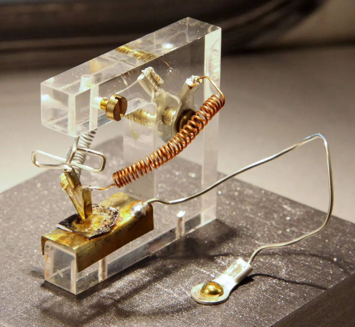 A replica of the first point-contact transistor: gold foil on a plastic wedge, pressed onto germanium by a spring