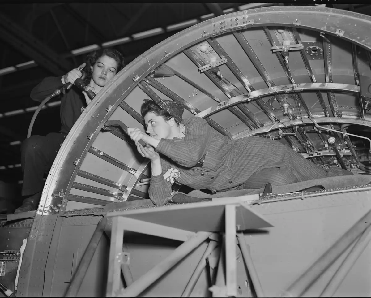 A team of women working inside a center wing section of a B-24E Liberator at Willow Run, 1942–43